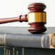 900-vecteezy_wooden-gavel-on-stack-of-aged-law-books_60746858