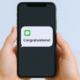 900_medium-vecteezy_close-up-of-hands-holding-smartphone-with-congratulations_70576965_medium