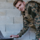 900_vecteezy_american-soldier-in-military-uniform-using-laptop-computer_31034731