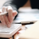 900_close-up-of-businesswoman-using-calculator_1231590_large