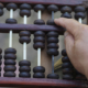 900_medium-vecteezy_close-up-man-hand-calculate-and-count-wooden-abacus_52255980_medium